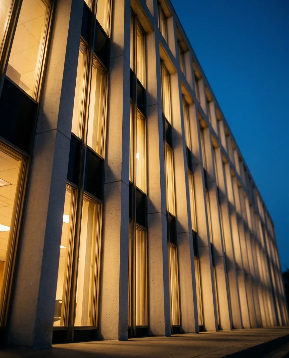 Federal facility columns glowing warm gold at dusk